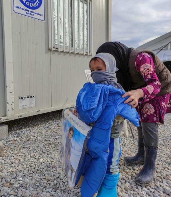 Réfugiée habillant son enfant